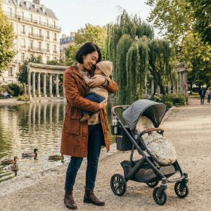 Mom holding baby in the park