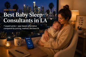 Best baby sleep consultants in LA 2026 guide cover — mother holding sleeping newborn at desk with Betteroo app visible on phone, Los Angeles skyline and palm trees through window