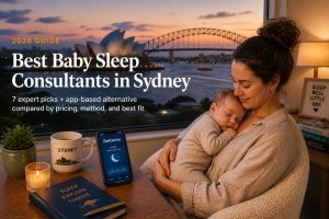 Sydney mother holding her sleeping baby by a window at dusk overlooking the Opera House and Harbour Bridge, with a Betteroo sleep app on her phone