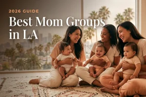 Smiling mothers with babies on a rug by a window, palm trees outside, with the heading: 'Best Mom Groups in LA' (2026 Guide).