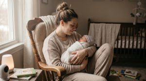 A first-time mom cradling her newborn in a quiet nursery, illustrating encouraging first time mom quotes.