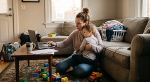 Singlemomquotes | Betteroo A single mom smiling while holding her child close at home, illustrating single mom quotes about strength.