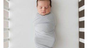 1 month old sleep schedule, baby sleeping safely on their back in a bare crib