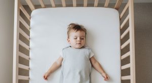 14 month old sleep schedule, baby sleeping safely on their back in a bare crib