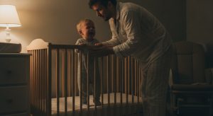 14 month sleep regression, tired parent soothing an awake baby at night