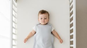 18montholdsleepschedulev4 | Betteroo 18 month old sleep schedule, baby sleeping safely on their back in a bare crib