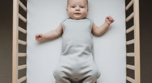 2 month old sleep schedule, baby sleeping safely on their back in a bare crib