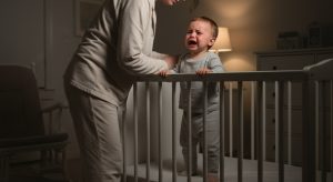 20 month sleep regression, tired parent soothing an awake baby at night