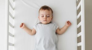 23 month old sleep schedule, baby sleeping safely on their back in a bare crib