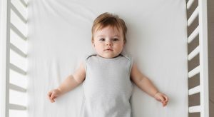 24 month old sleep schedule, baby sleeping safely on their back in a bare crib