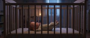 Baby sleeping on their back in an empty crib at night in soft moonlight, for a guide on when babies sleep through the night