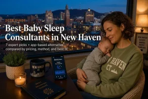 Mother in a green New Haven sweatshirt gently cradles a sleeping baby beside a window with a city skyline at dusk; overlay text announces 'Best Baby Sleep Consultants in New Haven'