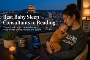 Tired Reading Pennsylvania mother holding her sleeping baby by a window at dusk, researching the best baby sleep consultants in Reading