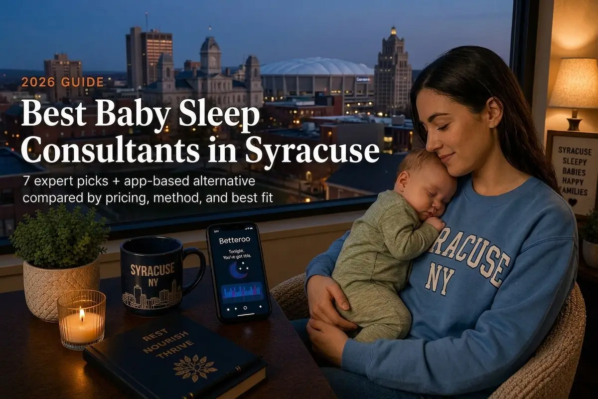 A mother cradling her sleeping baby by a window over the Syracuse skyline at dusk, best baby sleep consultants in Syracuse