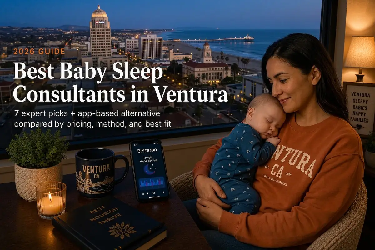 A mother cradling her sleeping baby by a window over the Ventura skyline at dusk, best baby sleep consultants in Ventura
