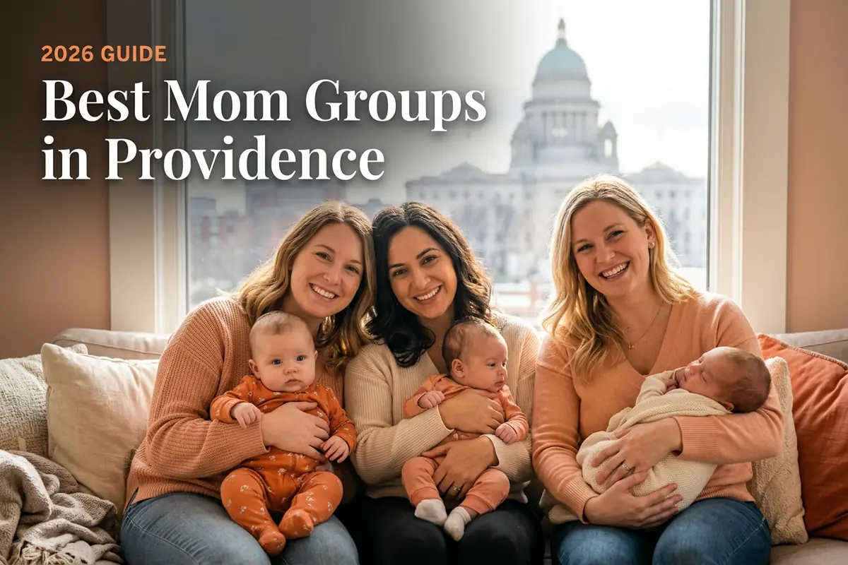 Three smiling moms sit on a couch with their babies, in front of a window, for a 2026 guide to Best Mom Groups in Providence.