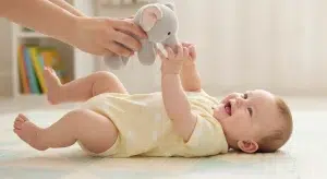 the Eat Play Sleep Routine How It Works and when to Use It | Betteroo Happy awake baby playing with a toy during play time