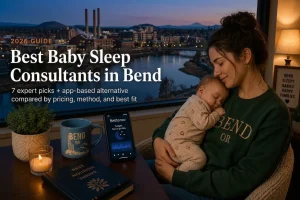 Best baby sleep consultants in Bend guide, a mother holding her sleeping baby above the dusk Deschutes River