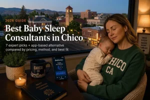 Best baby sleep consultants in Chico guide, a mother holding her sleeping baby above dusk downtown and foothills