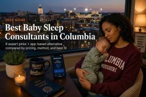 Mother holding sleeping baby at dusk researching baby sleep consultants in Columbia with the Mizzou campus skyline behind