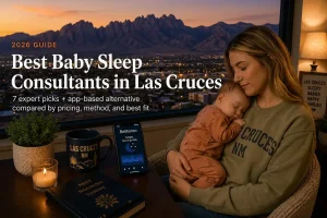 Mother holding a sleeping baby by a window over the Organ Mountains, baby sleep consultants in Las Cruces