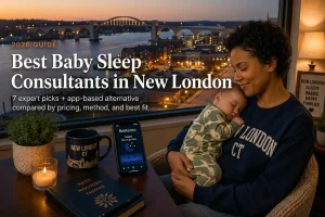 Mother holding a sleeping baby by a window over the Thames River, baby sleep consultants in New London