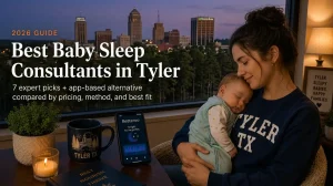 Best Baby Sleep Consultants in Tyler Tx 2026 | Betteroo Mother holding a sleeping baby by a window, guide to the best baby sleep consultants in Tyler with the Tyler skyline at dusk