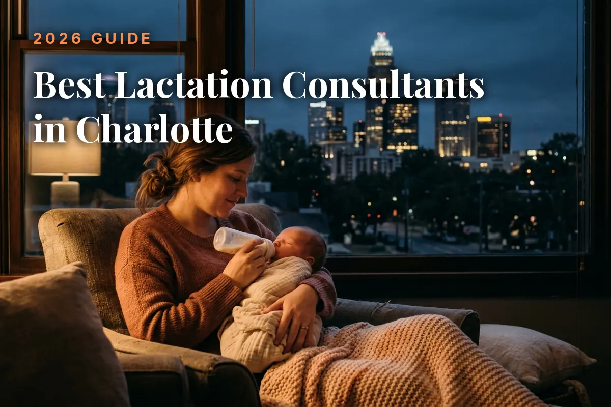 Mother feeding her baby by an evening window with the Charlotte skyline, cover image for the best lactation consultants in Charlotte guide