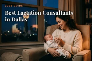 Mother feeding her baby by an evening window with the Dallas skyline, cover image for the best lactation consultants in Dallas guide