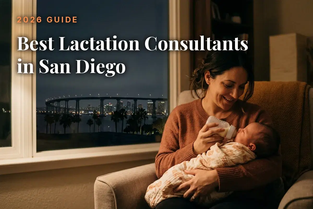 Mother feeding her baby by an evening window with the San Diego skyline, cover image for the best lactation consultants in San Diego guide