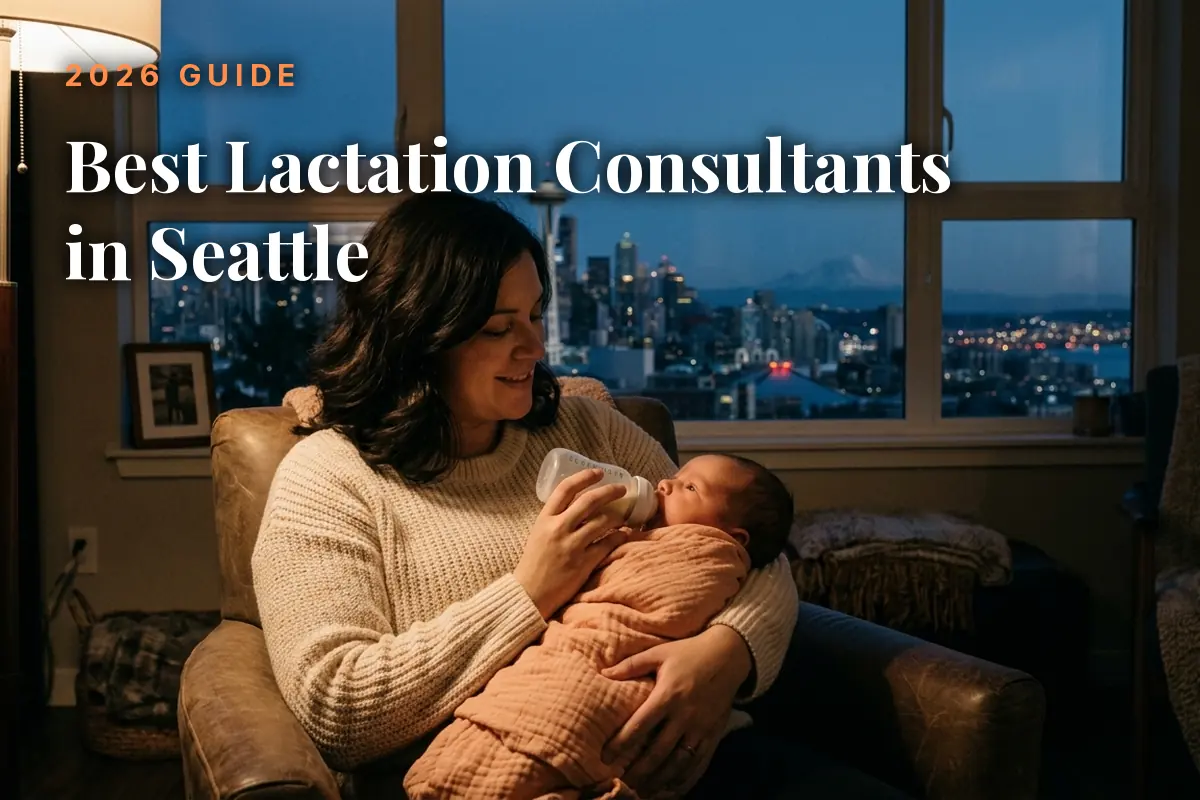 Mother feeding her baby by an evening window with the Seattle skyline, cover image for the best lactation consultants in Seattle guide