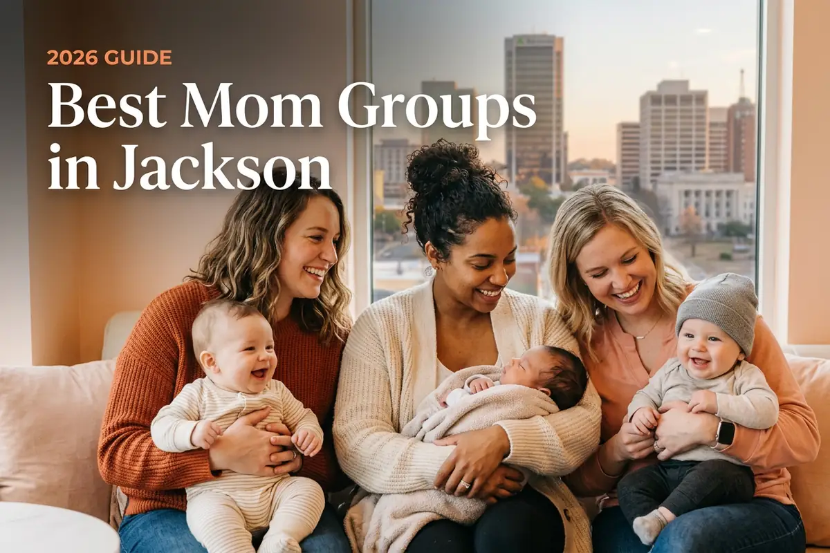 Four smiling moms hold babies on a sofa by a window with a city skyline; overlay text reads “2026 GUIDE Best Mom Groups in Jackson.”