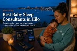 Mother cradling a sleeping baby at dusk above Hilo Bay, a guide to baby sleep consultants in Hilo