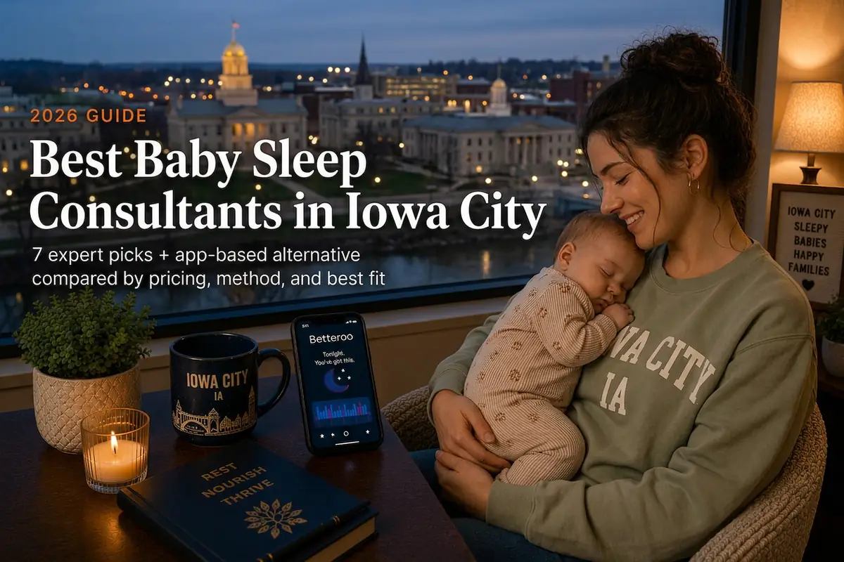 Mother holding a sleeping baby beside a window overlooking the gold Old Capitol dome, guide to baby sleep consultants in Iowa City Iowa