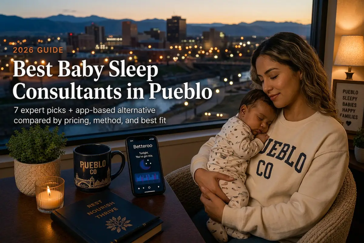 Mother holding a sleeping baby beside a window overlooking the Riverwalk and Rocky Mountain foothills, guide to baby sleep consultants in Pueblo Colorado