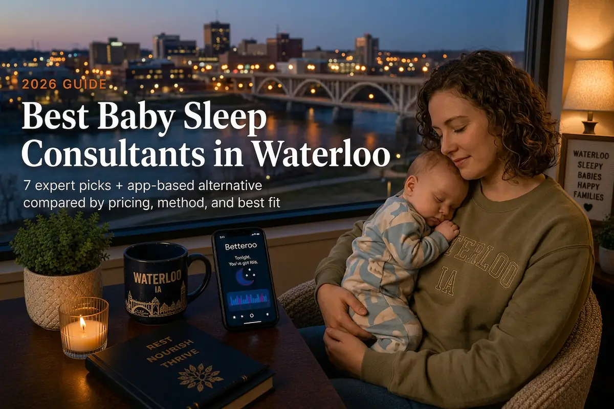 Mother holding a sleeping baby beside a window overlooking the Cedar River and downtown bridge, guide to baby sleep consultants in Waterloo Iowa