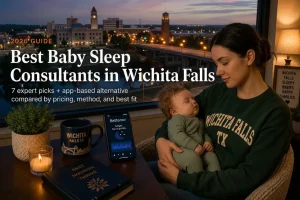 Mother holding a sleeping baby by a window overlooking the Wichita Falls Texas skyline at dusk, guide to baby sleep consultants in Wichita Falls