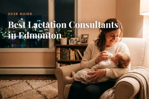 Mother feeding her baby at home in the evening in Edmonton, illustrating a guide to the best lactation consultants in Edmonton