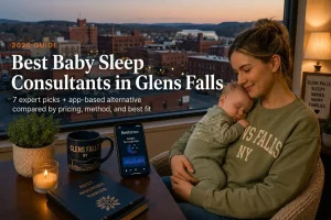 Mother holding a sleeping baby above the downtown skyline at dusk, baby sleep consultants in Glens Falls