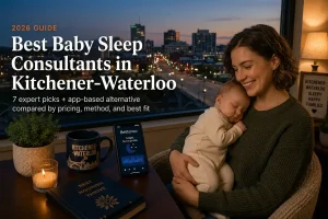 Mother rocking a sleeping baby by a window over downtown Kitchener-Waterloo at dusk, baby sleep consultants in Kitchener-Waterloo