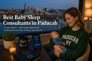 Mother holding sleeping baby by a window over the Ohio River at dusk, baby sleep consultants in Paducah