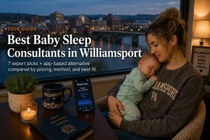 Mother holding sleeping baby by window over the Susquehanna River bridge at dusk, baby sleep consultants in Williamsport