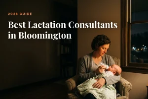 Mother feeding her baby at home in Bloomington at night, cover image for the Betteroo guide to the best lactation consultants in Bloomington in 2026