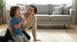A parent and a young child singing together in a living room while the child holds a toy microphone