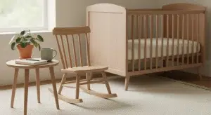A quiet nursery corner with a rocking chair, a blank notebook and pencil on a side table, and an empty crib in the background